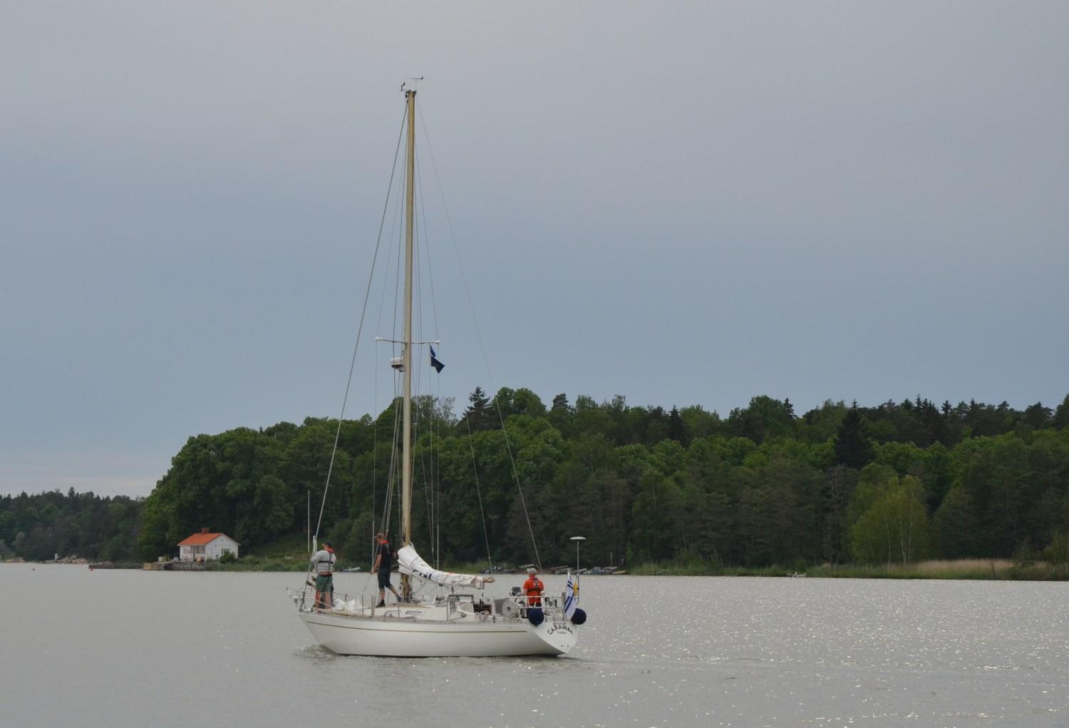 Segelbåt går för motor på en fjärd.