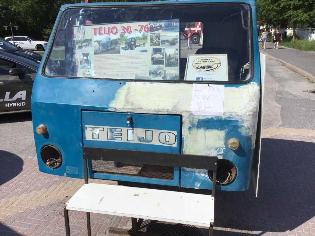 En sliten blå hytt med textej Teijo i framändan