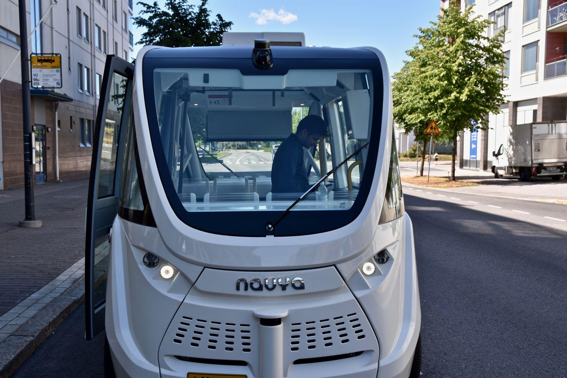 En grå självkörande buss i på en gata i Helsingfors.