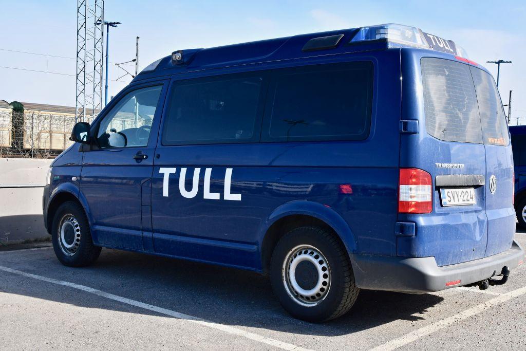 En blå bil med texten "Tull" skriven på sidan står parkerad.