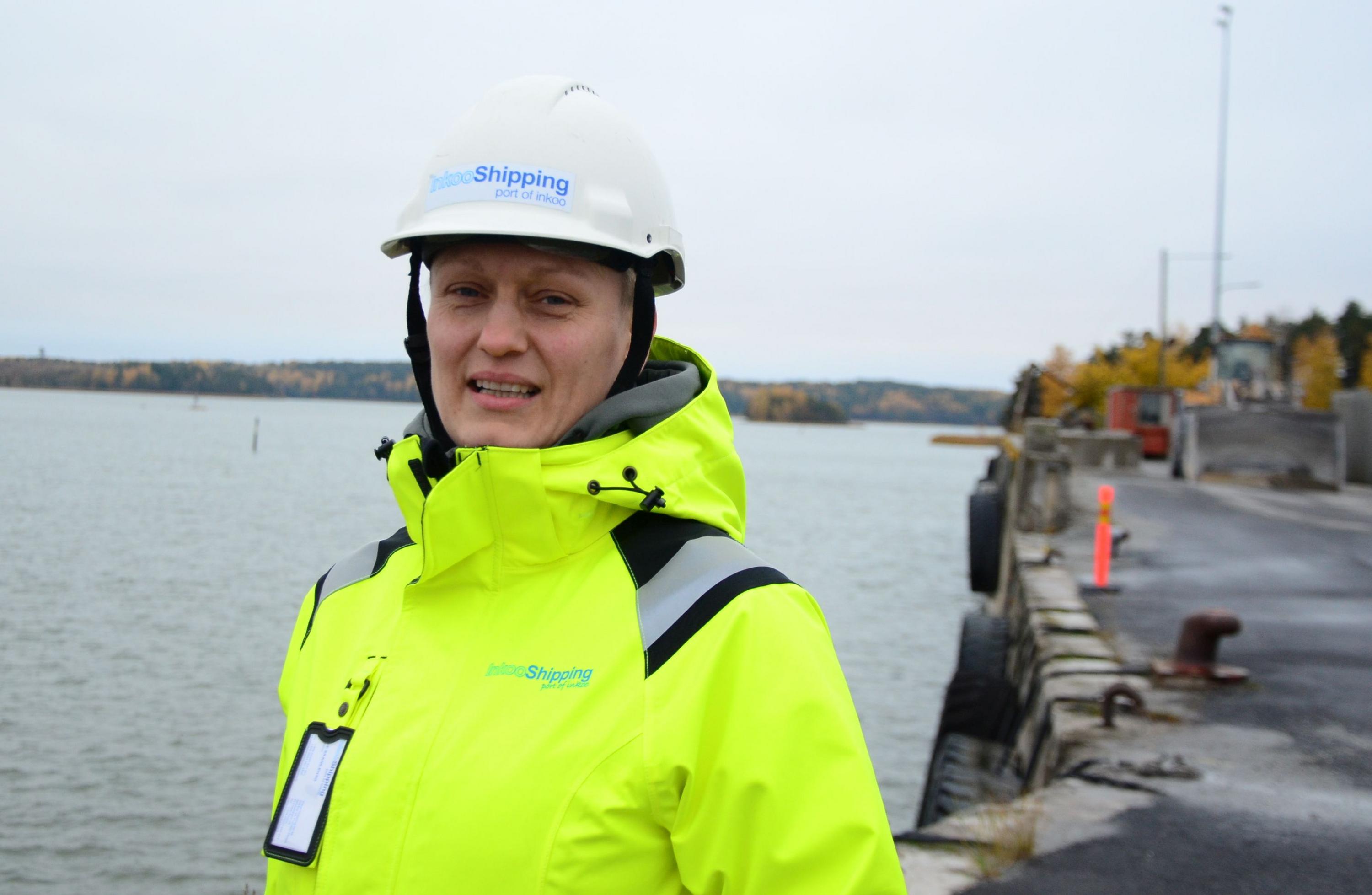 kvinna klädd i neongult och hjälm står i kalkhamnen i Pargas