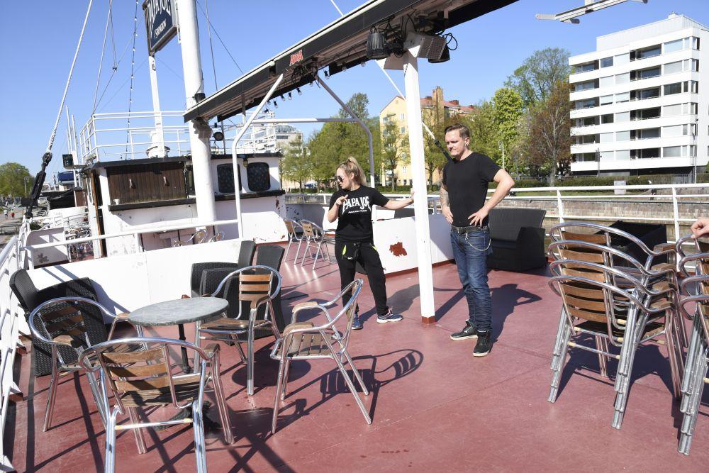 Restaurangarbetare ordnar bord på uteservering